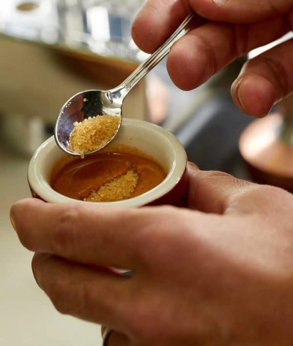 Delighting in an espresso shot: adding sugar to espresso
