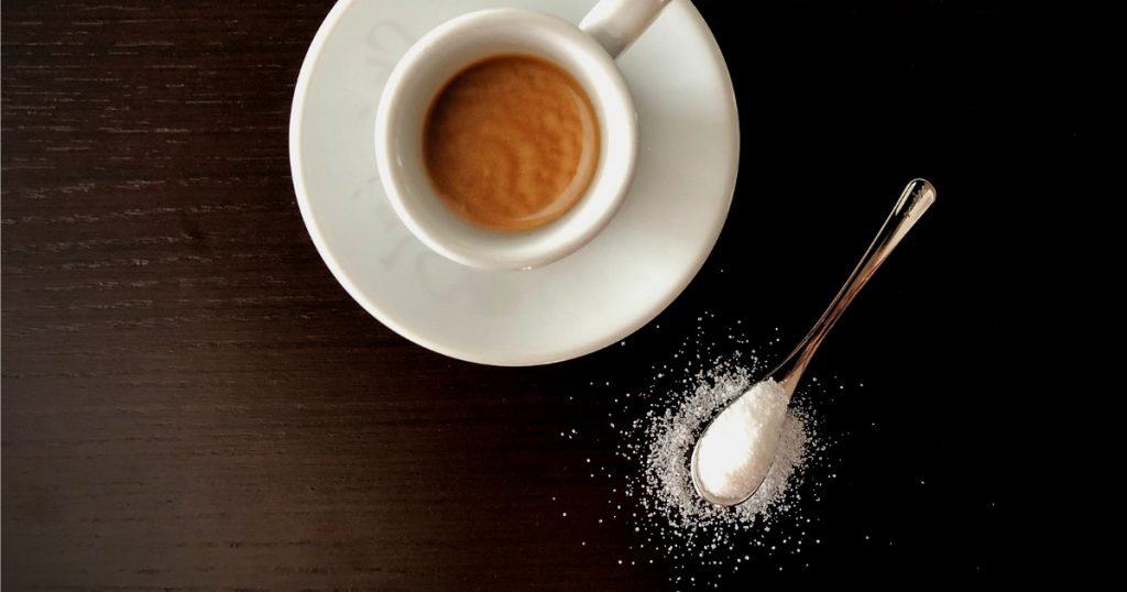 Delighting in an espresso shot: adding sugar 