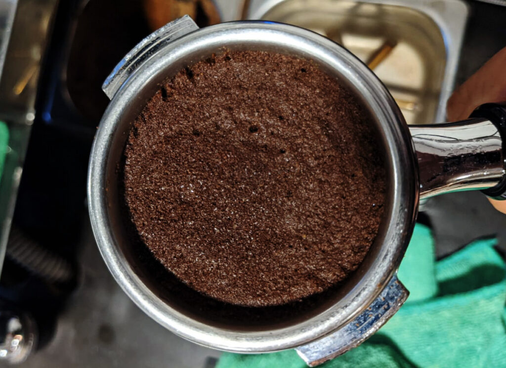 Finally, inspect the tamped coffee puck