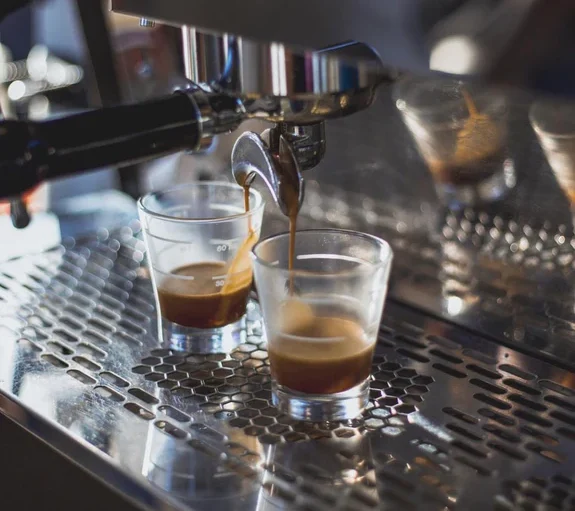 Barista pouring velvety shot of Sumatran espresso