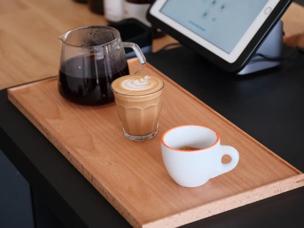 Barista preparing espresso flight with three different origins
