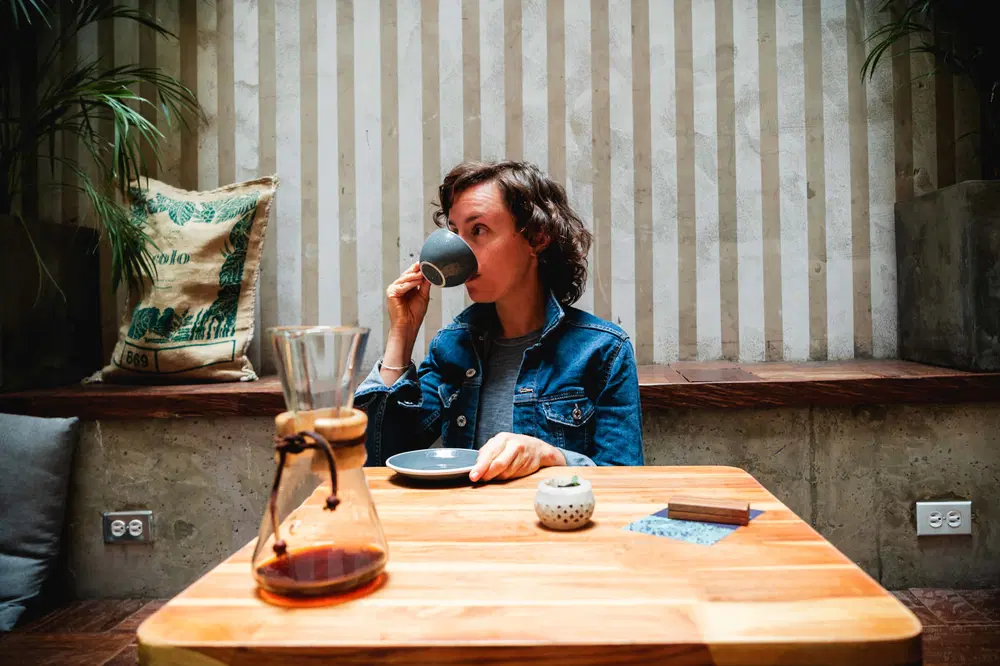 a girl drink a shot of Colombian espresso